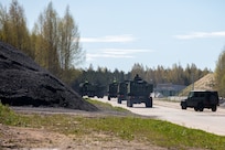Estonian soldiers drive multiple M142 High Mobility Artillery Rocket Systems (HIMARS) off the airfield at Amari Air Base, Estonia, April 29, 2025. In 2022, the U.S. State Department approved HIMARS sales to Estonia, which have now been received. Their arrival will give Estonia precise long-range artillery capabilities to strike deep behind enemy lines. (U.S. Army photo by Pfc. Jaidyn Moore)