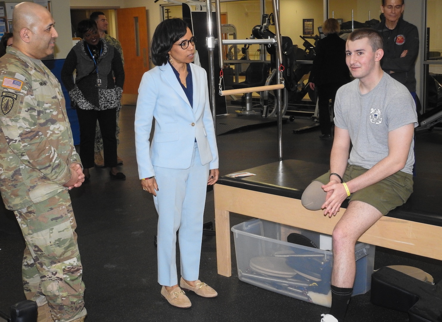 U.S. Senator Angela Alsobrooks of Maryland meets Samuel Kenyon (right), of the U.S. Coast Guard, in the Military Advanced Training Center at Walter Reed, where he and other patients receive physical therapy to help them adapt to their new abilities to improve their overall quality of life. U.S. Army Maj. Ajus Ninan (left), department chief of Walter Reed’s Warrior and Family Coordination Cell, looks on.