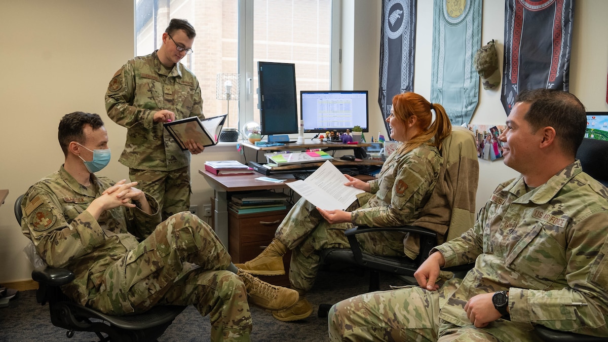 Image of a group of Airmen sitting in a circle and talking.
