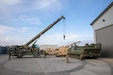 U.S. Army soldiers with Alpha Battery, 1st Battalion, 41st Field Artillery Regiment, and the Spanish Armed Forces work together to replace the engine on a U.S. M88A2 Hercules Armored Recovery Vehicle at Camp Adazi, Latvia, April 14, 2025. The Spanish Armed Forces assisted the U.S. with a Leopard 2ER Buffalo tracked recovery vehicle and a crane to replace an engine of an M88A2. V Corps and NATO Allies deter adversaries by demonstrating a combat-credible force through multinational training and exercises. (U.S. Army photo by Spc. Rachel Hall)