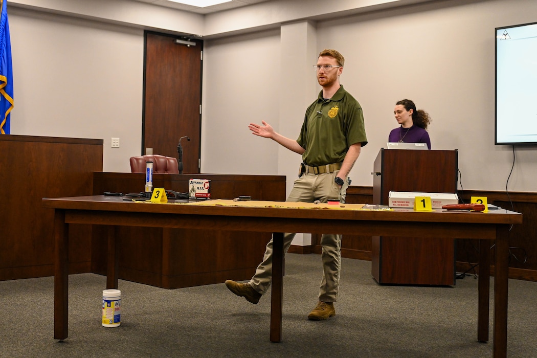 Special Agent Isaiah Moore, assigned to Air Force Office of Special Investigations detachment 422, explains forensic investigations to Altus Junior High School students at Altus Air Force Base, Oklahoma, May 1, 2025. This is Moore’s second year participating in Law Day. (U.S. Air Force photo by Senior Airman Kari Degraffenreed)
