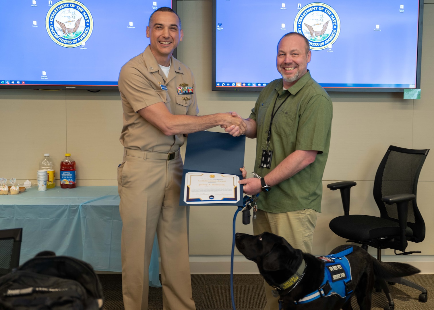 Naval Surface Warfare Center Carderock Division’s Commanding Officer, Capt. Chris Matassa presents Jeffrey Klimczak, a human resources specialist at Carderock, the Naval Sea Systems Command Human Resources (HR) Award for Collaboration at an HR All Hands in West Bethesda, Md. on April 29, 2025.
