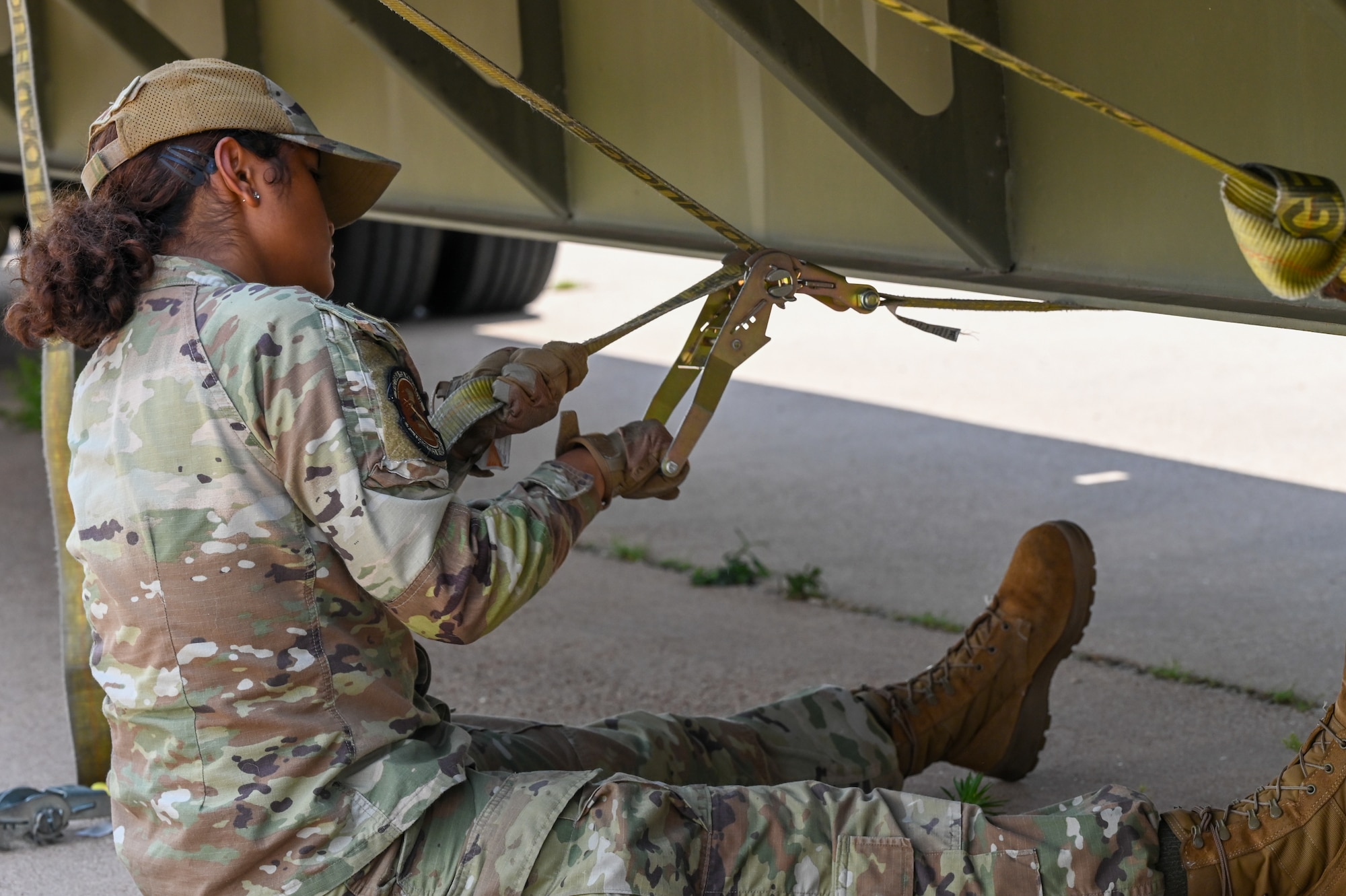 U.S. Air Force Airman Taliyah Lake, 7th Logistics Readiness Squadron ground transportation operator, secures pallets of food to a supply truck for the Denton Program in Abilene, Texas, April 28, 2025. The Denton Program allows private U.S. citizens and organizations to use space available on U.S. military cargo planes to transport humanitarian goods. (U.S. Air Force photo by Airman 1st Class Adrien Tran)
