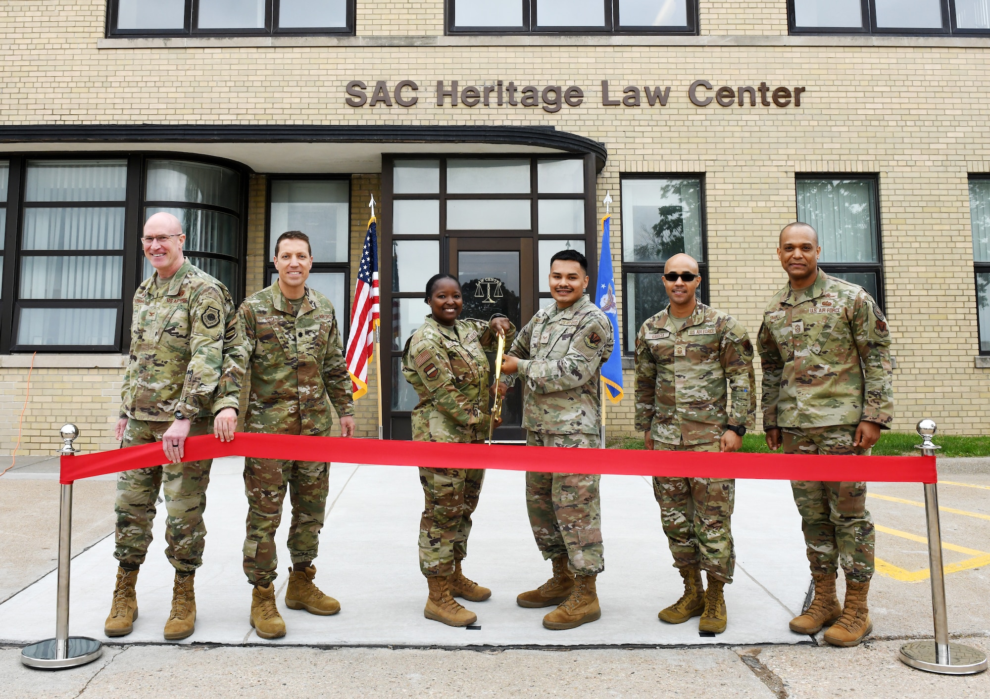 Airmen cut the ribbon in front of the SAC Heritage Law Center