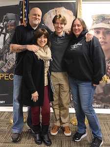 Retired SFC Michael Rafferty, Elijah Rafferty and Family pose after Elijas takes his oath