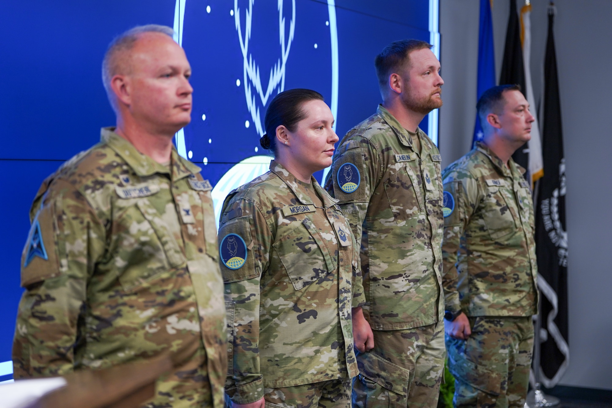 Four people standing at attention