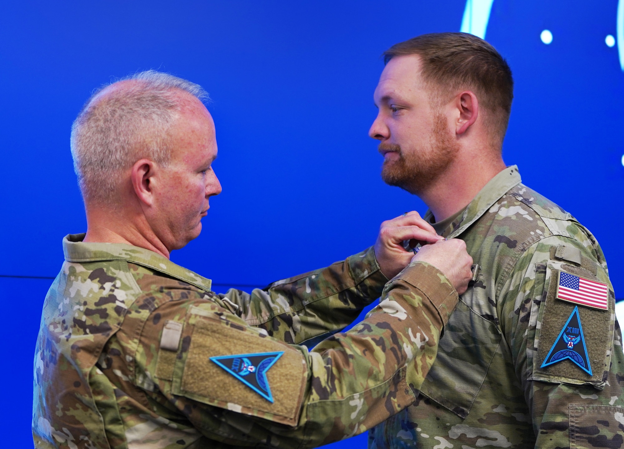 Photo of man pinning medal on another Guardian