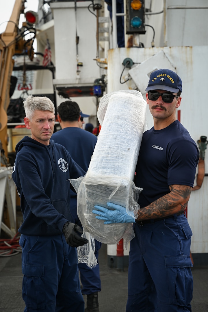 Crew members from Coast Guard Cutter Venturous (WMEC-625) offload bales of illegal drugs at Coast Guard Base Miami Beach, May 2, 2025. The seized contraband was the result of four interdictions in the Caribbean Sea by the crews of USCGC Diligence (WMEC-616) and HNLMS Groningen (P843) with an embarked Coast Guard law enforcement detachment. (U.S. Coast Guard photo by Petty Officer 3rd Class Jessica Walker)