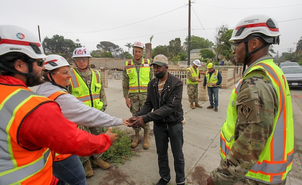 Darius Wallace, U.S. Army Corps of Engineers Los Angeles District employee and an Eaton Wildfire survivor, is greeted by USACE teammates April 30 outside his property in Altadena, California.