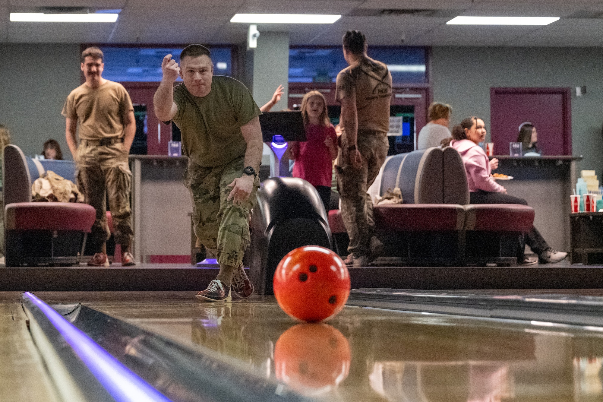 U.S. Air Force Senior Airman Gabriel Mueller, a respiratory care practitioner assigned the 673d Health Care Operations Squadron, rolls a bowling ball down a lane during the Strike-Out Sexual Assault event at Joint Base Elmendorf-Richardson, Alaska April 25.