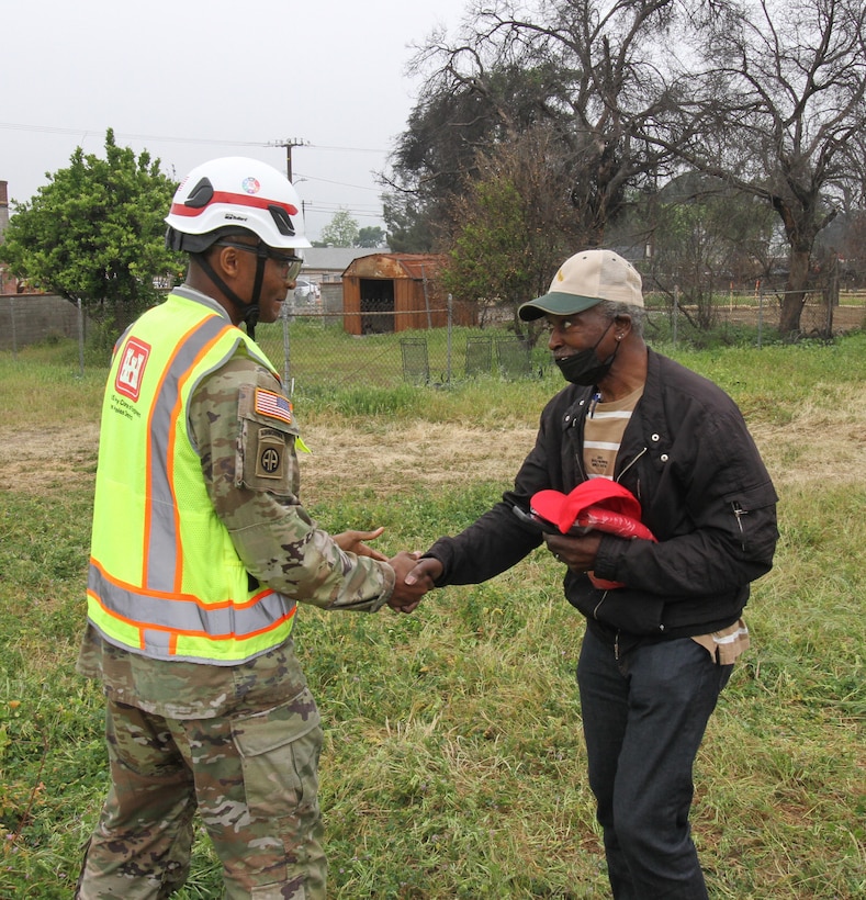 Darius Wallace, U.S. Army Corps of Engineers Los Angeles District employee and an Eaton Wildfire survivor, right, shakes hands with Lt. Col. Stephen Brooks, USACE LA District deputy commander, after a walkthrough of Wallace's property April 30 in Altadena, California.