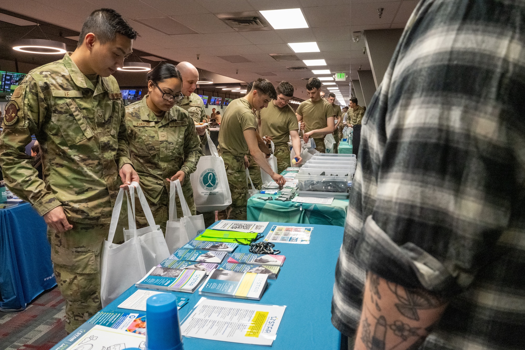 U.S. Air Force Airmen pick up souvenirs during a Sexual Assault Awareness Prevention Month event at Joint Base Elmendorf-Richardson, Alaska, April 25.