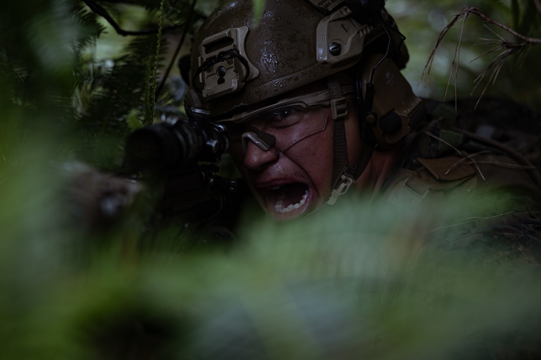 U.S. Marine Corps Lance Cpl. Nathanel Bass, an infantry Marine with 1st Light Armored Reconnaissance Company, Battalion Landing Team 1st Battalion, 7th Marine Regiment, 31st Marine Expeditionary Unit, simulates returning fire with an M4 Carbine while conducting a Tactical Recovery of Aircraft Personnel simulation as a part of MEU Exercise at Camp Hansen, Okinawa, Japan, May 1, 2025. The TRAP simulation showcased advanced trauma life support capabilities and evaluated the platoon’s rapid response and recovery tactics of downed aircraft, personnel and equipment in isolated locations. The 31st MEU, the Marine Corps’ only continuously forward-deployed MEU, provides a flexible and lethal force ready to perform a wide range of military operations as the premiere crisis response force in the Indo-Pacific region. Bass is a native of Arizona. (U.S. Marine Corps photo by Lance Cpl. Raul Sotovilla)