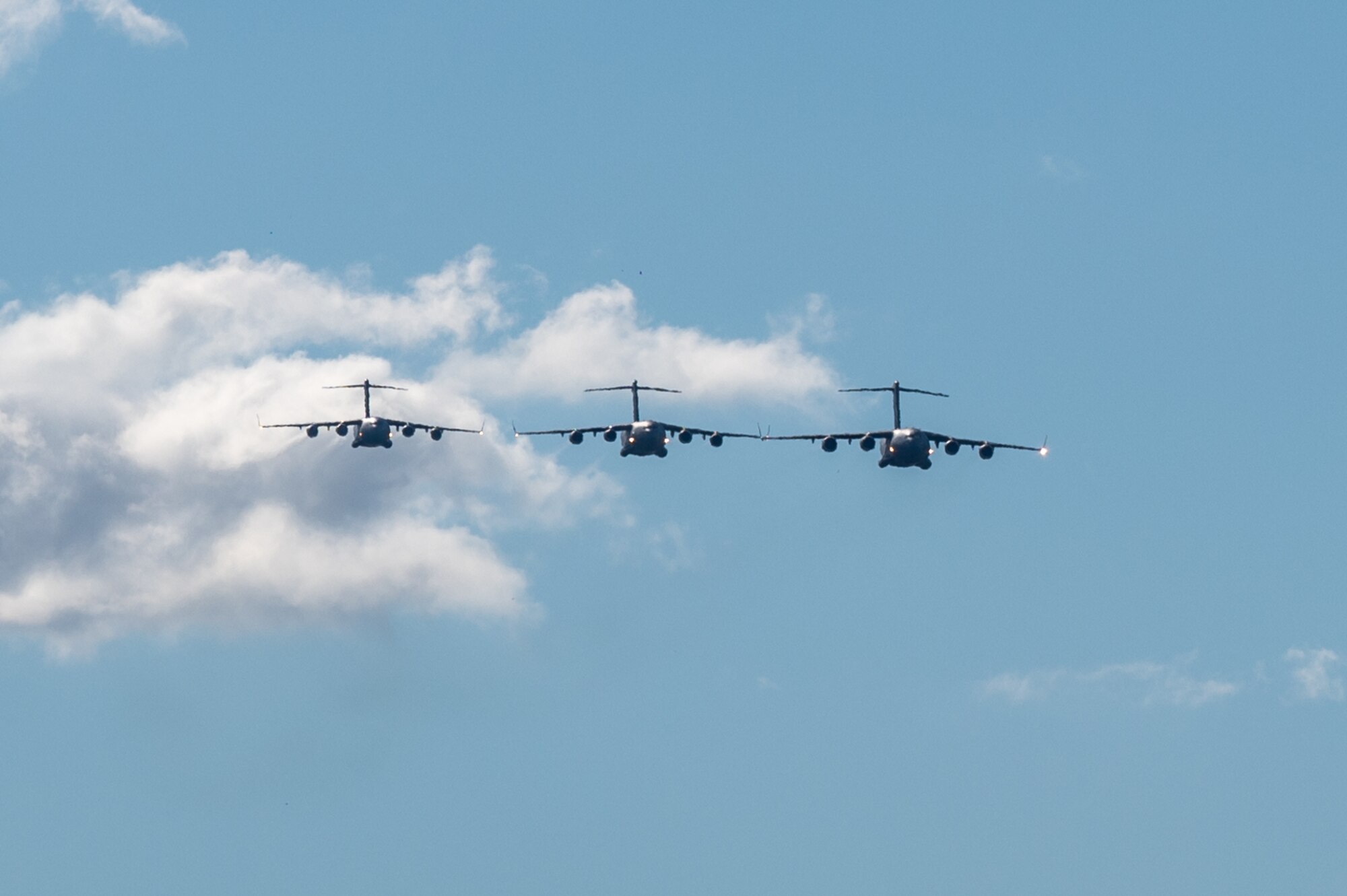 Three C-17 Globemaster IIIs from the Royal Australian Air Force, U.S. Air Force and Royal Canadian Air Force conduct a three-ship formation during Global Dexterity 25.