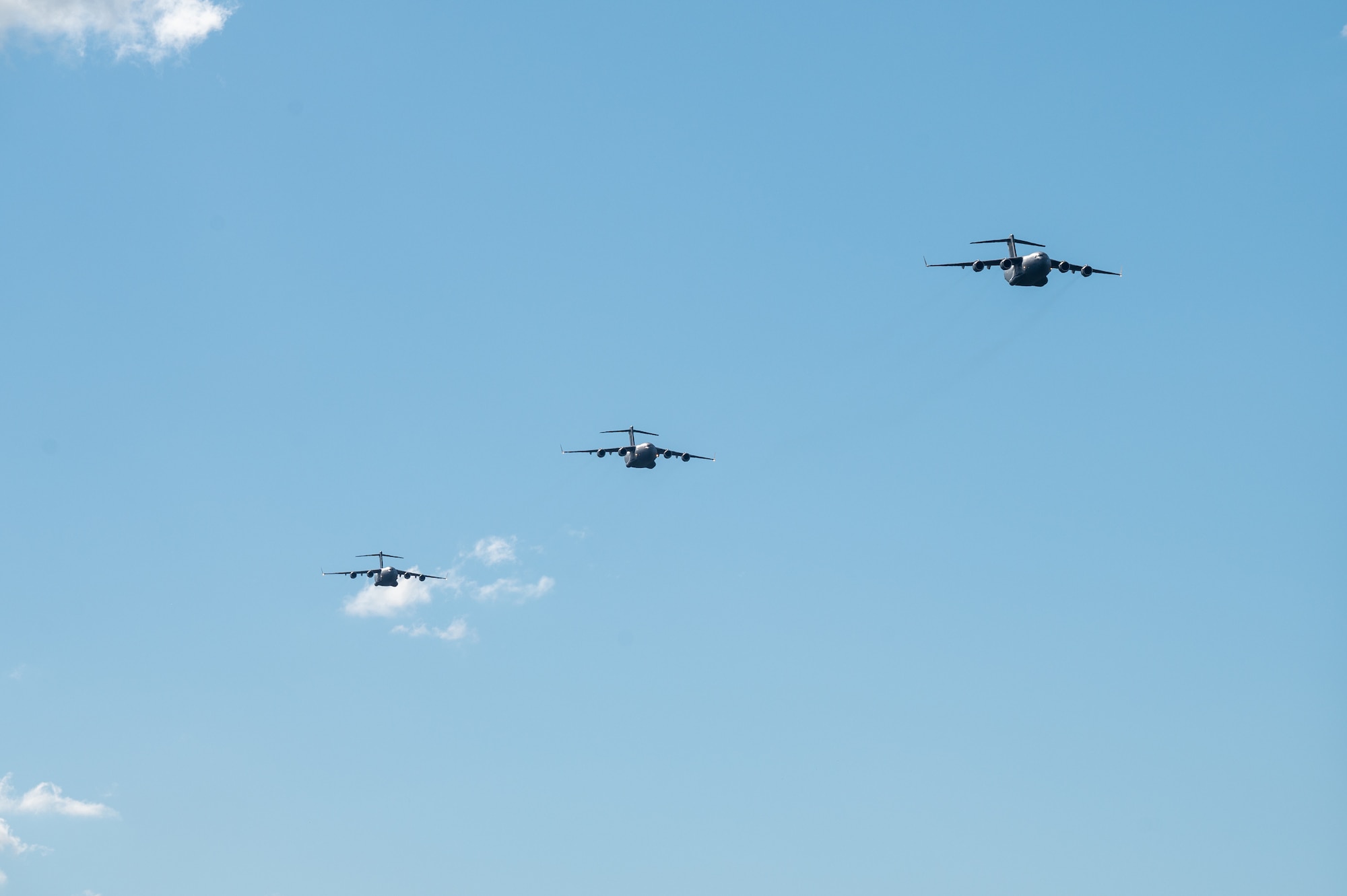 Three C-17 Globemaster IIIs from the Royal Australian Air Force, U.S. Air Force and Royal Canadian Air Force conduct a three-ship formation during Global Dexterity 25.