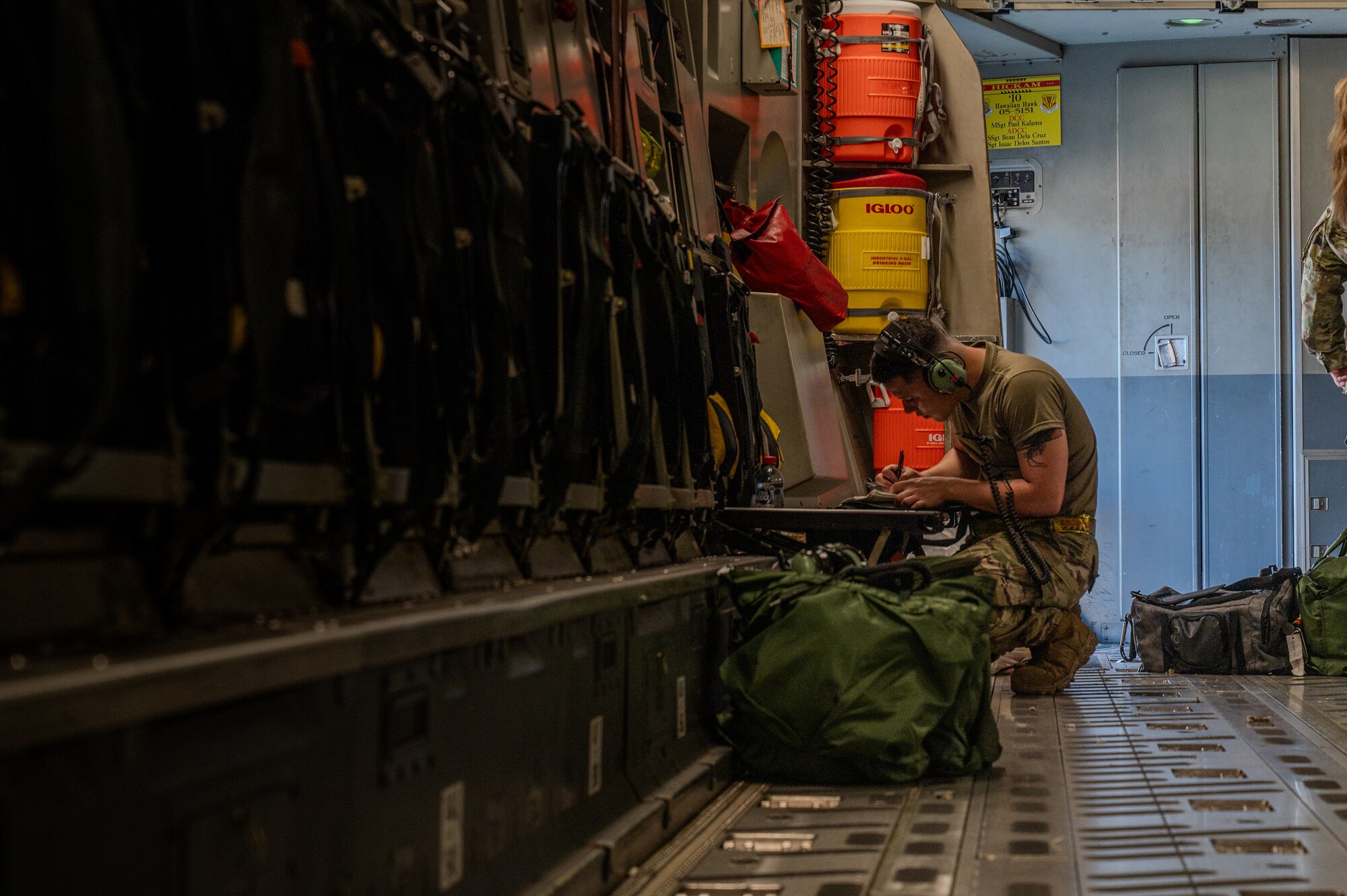 A U.S. Air Force Airmen puts together his gear inside of a C-17 Globemaster III.