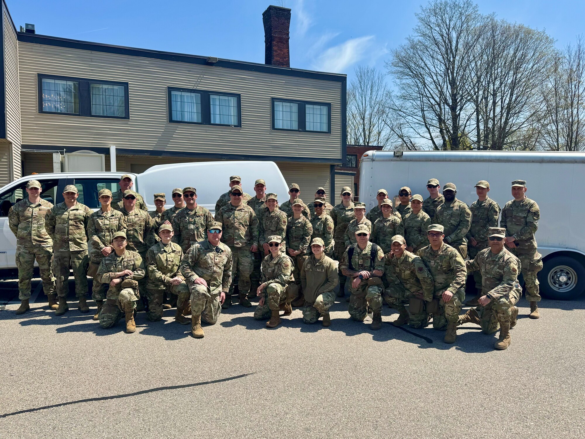 A photo of a large group of military medics standing outdoors in preparation for emergency medial operations.