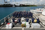 The crew members from Coast Guard Cutter Venturous pose before preparing to offload a pallet of illegal narcotics at Coast Guard Base Miami Beach, May 2, 2025. The seized contraband was the result of four interdictions in the Caribbean Sea by the crews of USCGC Diligence (WMEC-616) and HNLMS Groningen (P843) with an embarked Coast Guard law enforcement detachment. (U.S. Coast Guard photo by Petty Officer 3rd Class Jessica Walker)