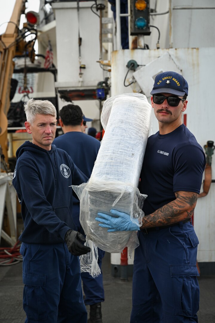 Crew members from Coast Guard Cutter Venturous (WMEC-625) offload bales of illegal drugs at Coast Guard Base Miami Beach, May 2, 2025. The seized contraband was the result of four interdictions in the Caribbean Sea by the crews of USCGC Diligence (WMEC-616) and HNLMS Groningen (P843) with an embarked Coast Guard law enforcement detachment. (U.S. Coast Guard photo by Petty Officer 3rd Class Jessica Walker)