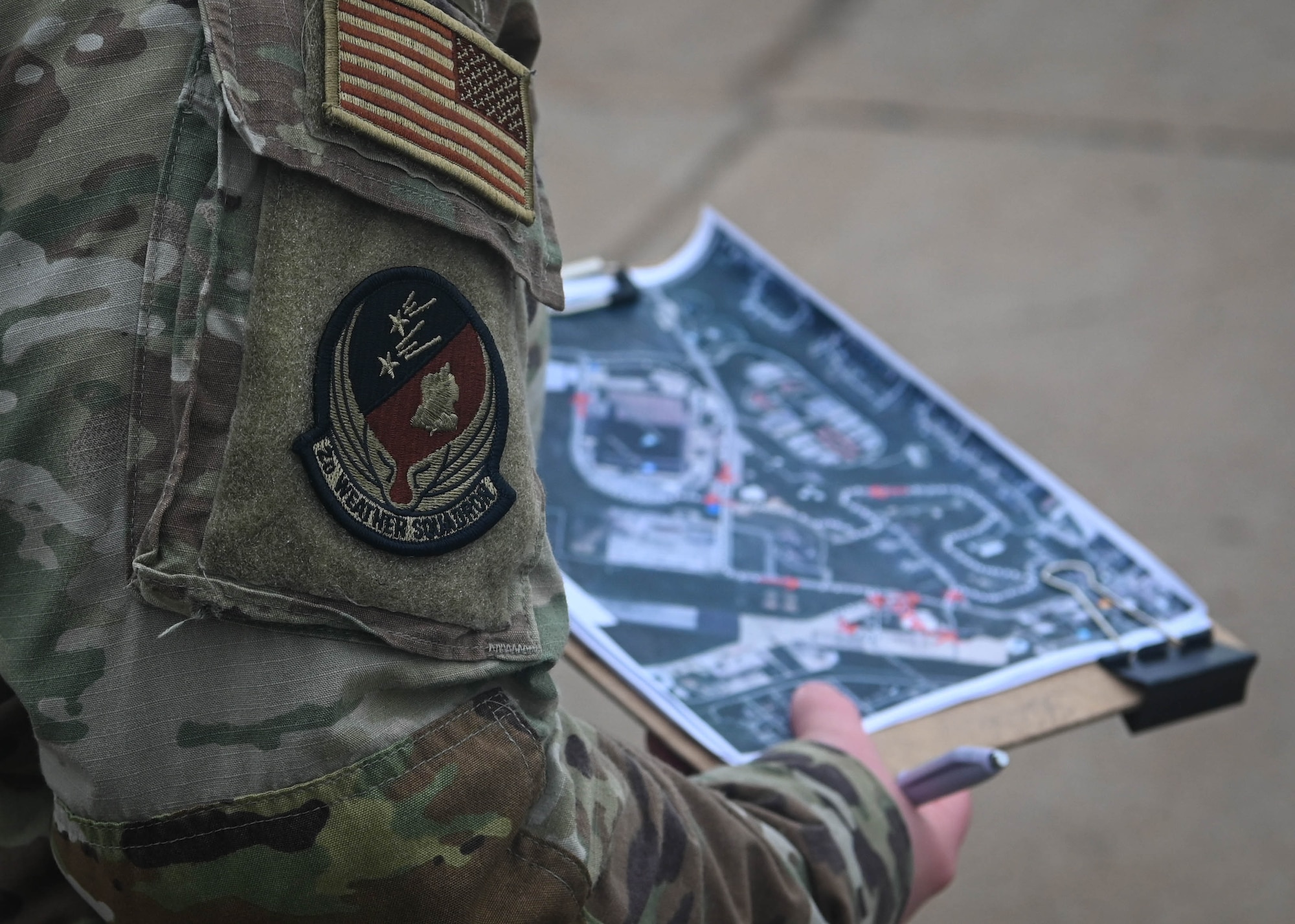 Staff Sgt. Katherine Ratliff Boomer, 2nd Weather Squadron unit training manager and event organizer, holds a picture of the route for the Capt. Nathan Nylander Memorial ruck march at the 557th Weather Wing, April 25, 2025. Ratliff Boomer organized the event with the help of other base agencies. (U.S. Air Force photo by Daniel Martinez)