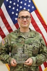 U.S. Army 1st Sgt. Gerald Funk, chief instructor for 2nd Battalion, 166th Regiment – Regional Training Institute, Pennsylvania Army National Guard, holds a quality assurance evaluator of the year award that he received during a U.S. Army quality assurance program forum at Fort Eustis, Va. in March of 2025. Funk served as a quality assurance noncommissioned officer for 3rd Battalion, 166th Regiment from Feb. 2018 to April 2025. (U.S. Army National Guard photo by Sgt. 1st Class Shane Smith)