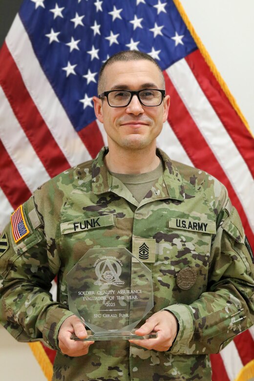 U.S. Army 1st Sgt. Gerald Funk, chief instructor for 2nd Battalion, 166th Regiment – Regional Training Institute, Pennsylvania Army National Guard, holds a quality assurance evaluator of the year award that he received during a U.S. Army quality assurance program forum at Fort Eustis, Va. in March of 2025. Funk served as a quality assurance noncommissioned officer for 3rd Battalion, 166th Regiment from Feb. 2018 to April 2025. (U.S. Army National Guard photo by Sgt. 1st Class Shane Smith)