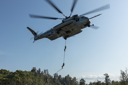 U.S. Marines with Animal Company, Battalion Landing Team 1st Battalion, 7th Marine Regiment, 31st Marine Expeditionary Unit, fast rope from a CH-53E Super Stallion helicopter assigned to Marine Medium Tilt Rotor Squadron 265 (Rein.) during aerial fast rope training as a part of MEU Exercise at Camp Hansen, Okinawa, Japan, Apr. 30, 2025. Marines participated in fast rope training to enhance air-to-ground insertion capabilities during MEUEX to prepare for future operations. The 31st MEU, the Marine Corps’ only continuously forward-deployed MEU, provides a flexible and lethal force, ready to perform a wide range of military operations as the premiere crisis response force in the Indo-Pacific region. (U.S. Marine Corps photo by Lance Cpl. Victor Gurrola).