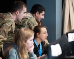 Air Force Institute of Technology students work with Mariah Flatt, with glasses, and Ava Latino, both Greenon High School Students, as they learn and practice basic computer hacking techniques April 23, 2025, during the annual AFIT Engineering Day on the school’s campus at Wright-State Air Force Base, Ohio. Each year, AFIT invites Dayton area students to the school’s campus to learn about STEM and how it relates to the Air Force. (U.S. Air Force photo by R.J. Oriez)