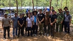 Tech. Sgt. Joshua Sims, an Explosive Ordnance Disposal technician assigned as a Defense POW/MIA Accounting Agency short term individual augmentee, and the DPAA Accounting Agency recovery team, Vietnamese Office for Seeking Missing Persons officials, and local Vietnamese workers pose for a photo after completing recovery operations in Vietnam on April 11, 2025.
