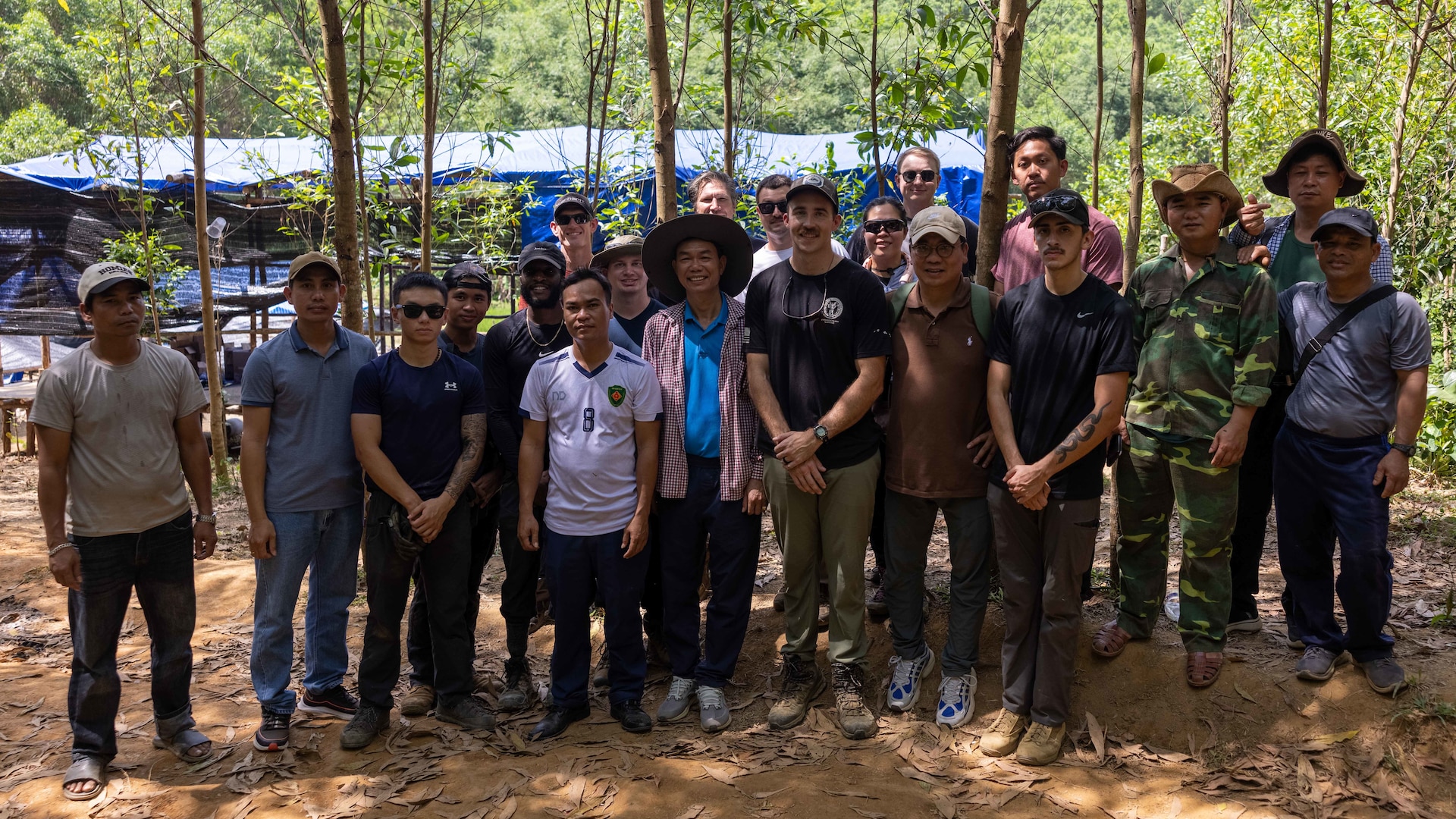 Tech. Sgt. Joshua Sims, an Explosive Ordnance Disposal technician assigned as a Defense POW/MIA Accounting Agency short term individual augmentee, and the DPAA Accounting Agency recovery team, Vietnamese Office for Seeking Missing Persons officials, and local Vietnamese workers pose for a photo after completing recovery operations in Vietnam on April 11, 2025.