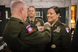 U.S. Army Chief Warrant Officer 5 Jennifer Ritchie smiles as Maj. Gen. Haldane Lamberton, Kentucky’s adjutant general, places the command chief warrant officer insignia on Ritchie's uniform at the command chief warrant officer change of responsibility at the State Capitol Rotunda in Frankfort, Ky. on April 29, 2025. Ritchie was appointed as the Kentucky Army National Guard command chief warrant officer during the ceremony, held previously by Chief Warrant Officer 5 Rickey Skelton. (U.S. Army photo by Andy Dickson)