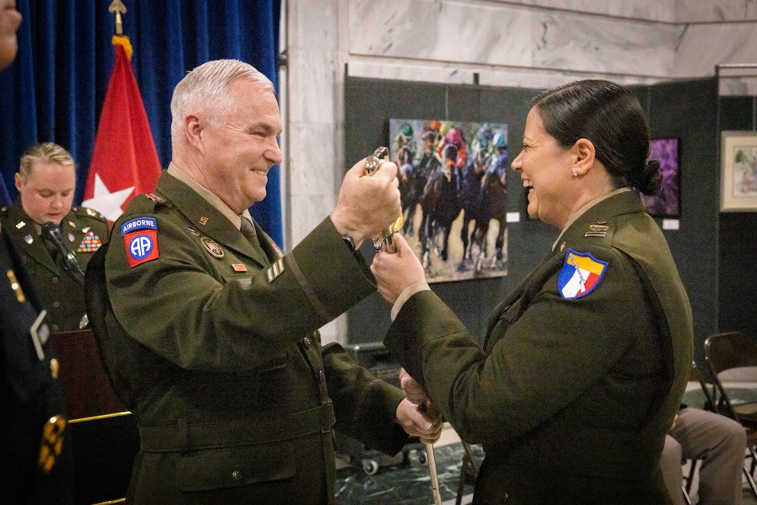 U.S. Army Command Chief Warrant Officer 5 Jennifer Ritchie (right), receives the warrant officer’s saber from Maj. Gen. Haldane Lamberton, Kentucky’s adjutant general, at the command chief warrant officer change of responsibility at the State Capitol Rotunda in Frankfort, Ky. on April 29, 2025. Ritchie was appointed as the Kentucky Army National Guard command chief warrant officer during the ceremony, held previously by Chief Warrant Officer 5 Rickey Skelton. (U.S. Army photo by Andy Dickson)