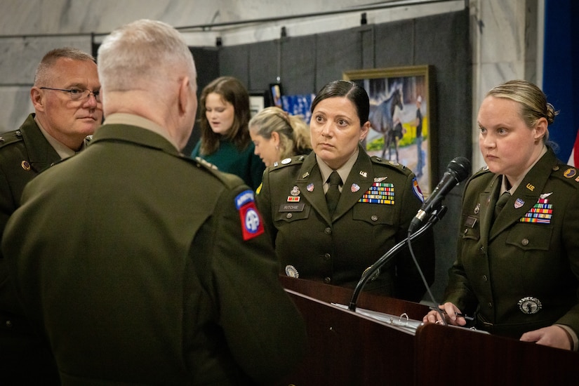 U.S. Army Chief Warrant Officer 5 Jennifer Ritchie (center), and Chief Warrant Officer 2 Amanda Marlow (right), listens to Maj. Gen. Haldane Lamberton prepare for the command chief warrant officer change of responsibility at the State Capitol Rotunda in Frankfort, Ky. on April 29, 2025. Ritchie was appointed as the Kentucky Army National Guard command chief warrant officer during the ceremony, held previously by Chief Warrant Officer 5 Rickey Skelton. (U.S. Army photo by Andy Dickson)