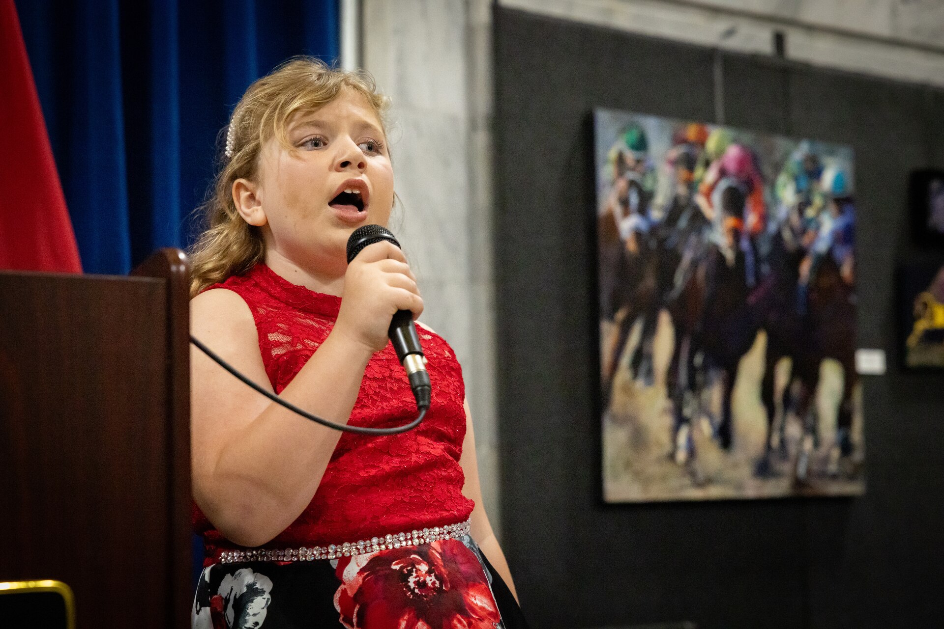 Ms. Macy Gesner, age 7 and niece of Chief Warrant Officer 5 Jennifer Ritchie, sang the national anthem at the command chief warrant officer change of responsibility at the State Capitol Rotunda in Frankfort, Ky. on April 29, 2025. Chief Warrant Officer 5 Jennifer Ritchie was appointed as the Kentucky Army National Guard command chief warrant officer during the ceremony, held previously by Chief Warrant Officer 5 Rickey Skelton. (U.S. Army photo by Andy Dickson)