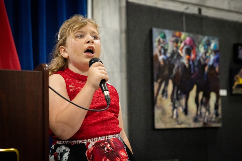 Ms. Macy Gesner, age 7 and niece of Chief Warrant Officer 5 Jennifer Ritchie, sang the national anthem at the command chief warrant officer change of responsibility at the State Capitol Rotunda in Frankfort, Ky. on April 29, 2025. Chief Warrant Officer 5 Jennifer Ritchie was appointed as the Kentucky Army National Guard command chief warrant officer during the ceremony, held previously by Chief Warrant Officer 5 Rickey Skelton. (U.S. Army photo by Andy Dickson)