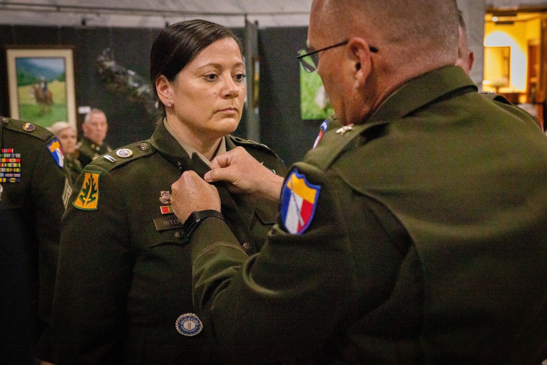 U.S. Army Chief Warrant Officer 5 Jennifer Ritchie stands at attention while Brig. Gen. Joseph Lear, director of the joint staff, removes Ritchie’s branch insignia at the command chief warrant officer change of responsibility at the State Capitol Rotunda in Frankfort, Ky. on April 29, 2025. Ritchie was appointed as the Kentucky Army National Guard command chief warrant officer during the ceremony, held previously by Chief Warrant Officer 5 Rickey Skelton. (U.S. Army photo by Andy Dickson)