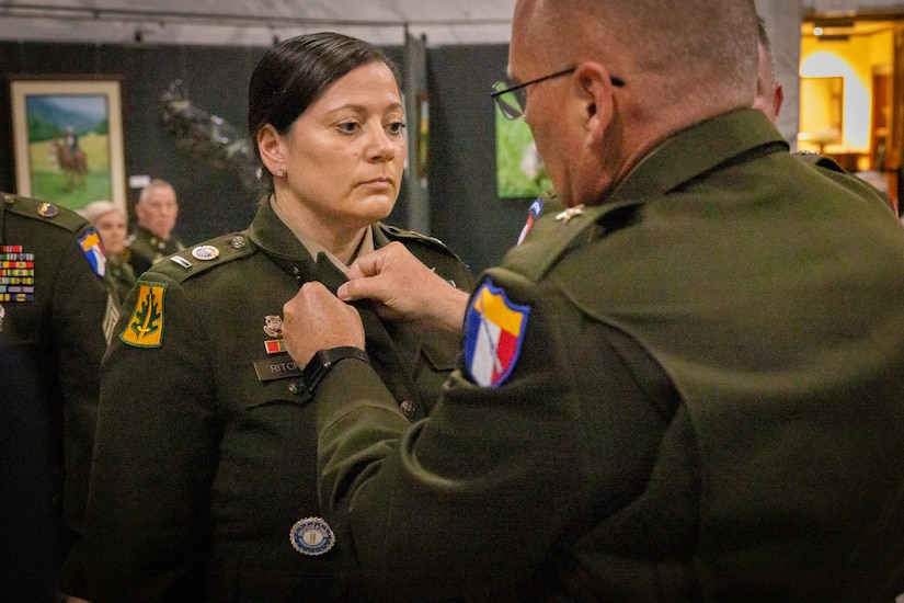 U.S. Army Chief Warrant Officer 5 Jennifer Ritchie stands at attention while Brig. Gen. Joseph Lear, director of the joint staff, removes Ritchie’s branch insignia at the command chief warrant officer change of responsibility at the State Capitol Rotunda in Frankfort, Ky. on April 29, 2025. Ritchie was appointed as the Kentucky Army National Guard command chief warrant officer during the ceremony, held previously by Chief Warrant Officer 5 Rickey Skelton. (U.S. Army photo by Andy Dickson)