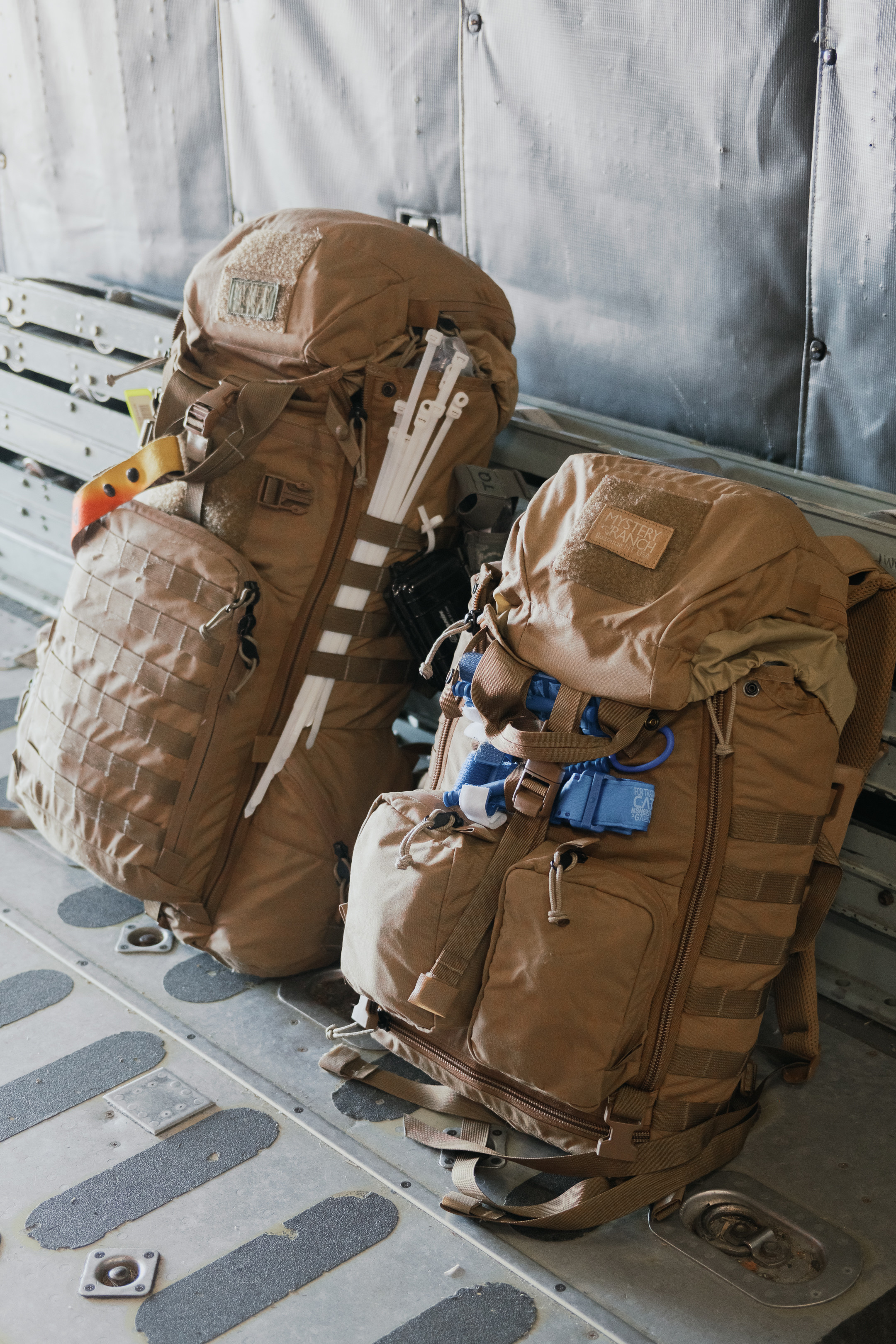 Two 375th Aeromedical Evacuation Squadron equipment backpacks, packed to the brim, sit side by side on a C-130J trainer fuselage, Jan. 24, 2025, at Scott Air Force Base, Ill. This is part of a pilot program the 375th AES is testing to find more agile and flexible ways of operating. “We’re testing various approaches — not just to see if they work,” said Maj. Brendan Arbuckle, 375th AES chief of tactics, “but to train our minds to think differently and adapt to evolving situations.” (U.S. Air Force photo by Delano Scott)