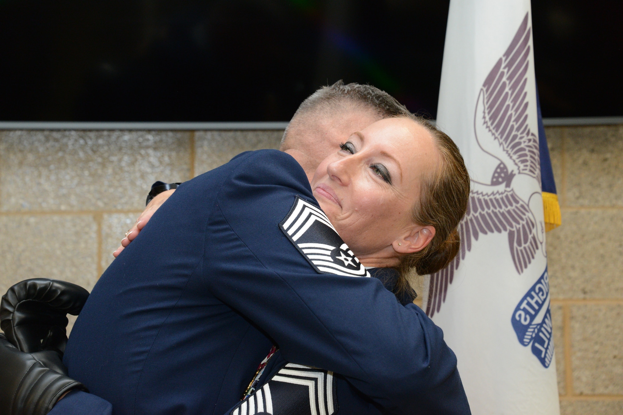 Chief Master Sgt. Valerie Rose, retired 185th Maintenance Group Chief, right, hugs her husband, Chief Master Sgt. Bradley Rose, 185th Maintenance Group Chief, left