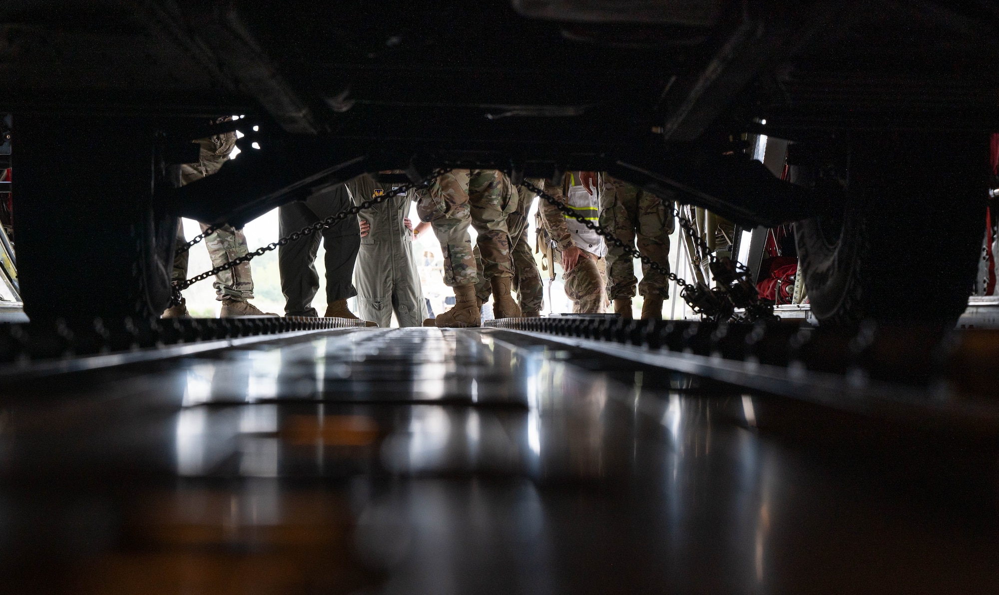 U.S. Airmen prepare to load a vehicle onto an aircraft