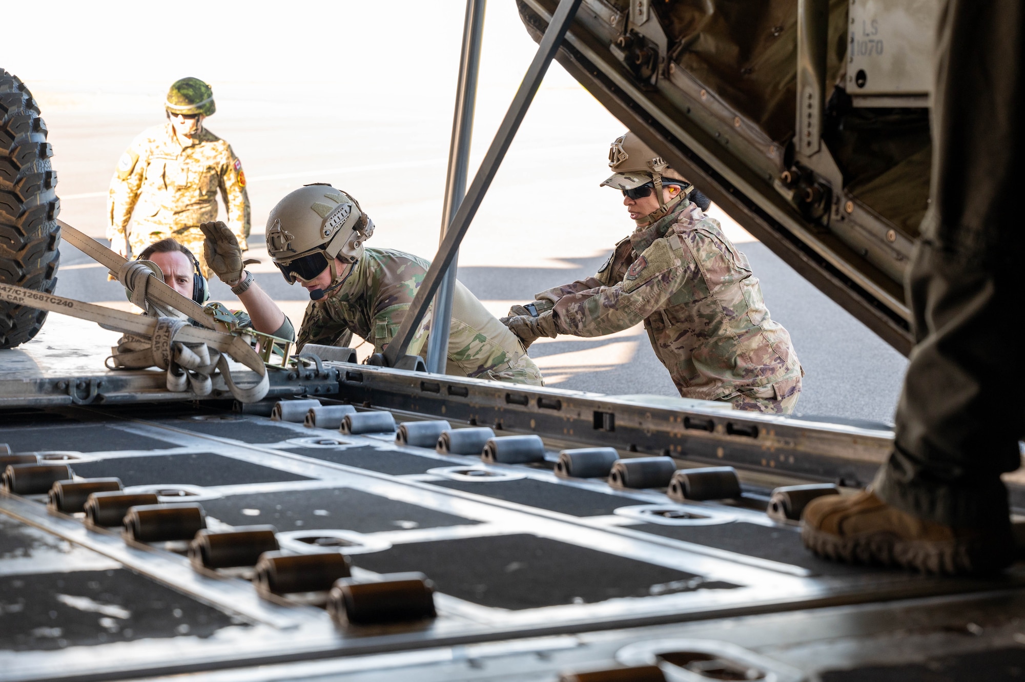 U.S. Airmen offload a vehicle from an aircraft