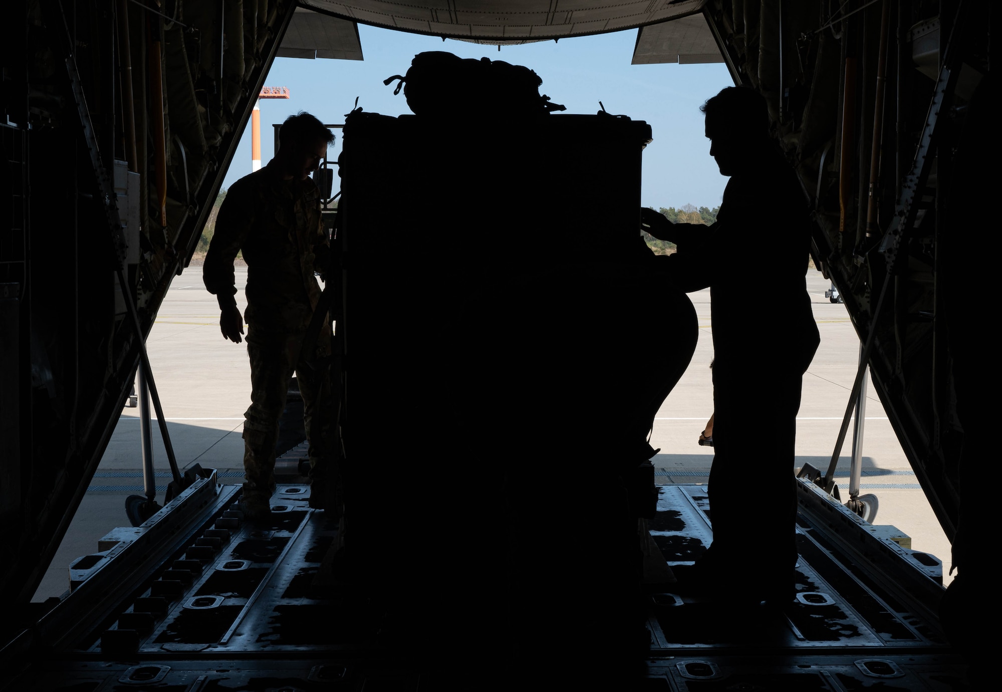 U.S. Airmen secure cargo inside of an aircraft