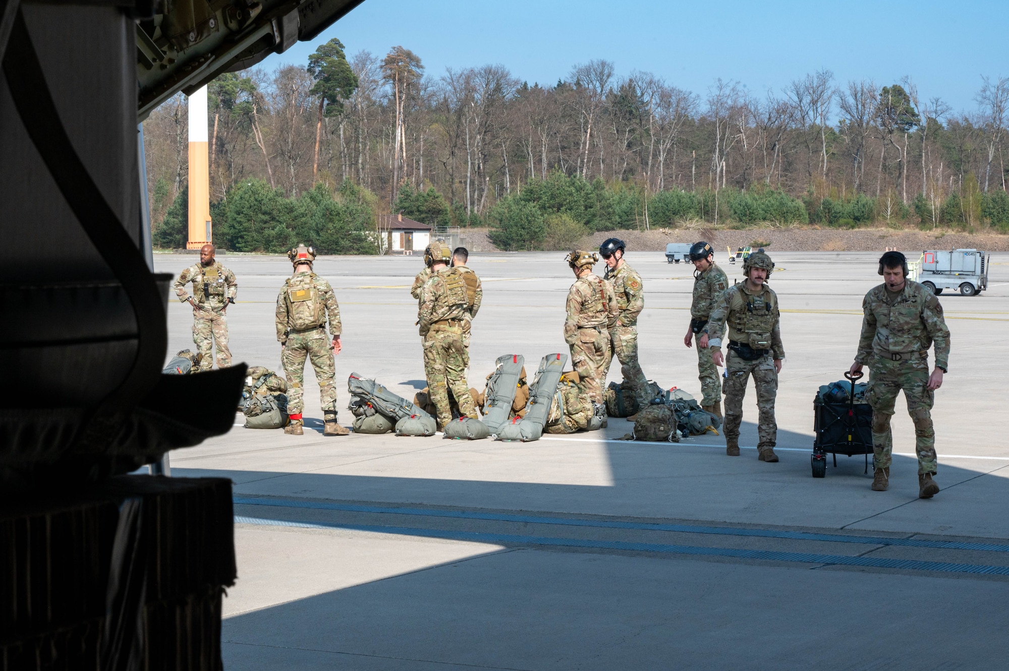 U.S. Airmen wait to board an aircraft