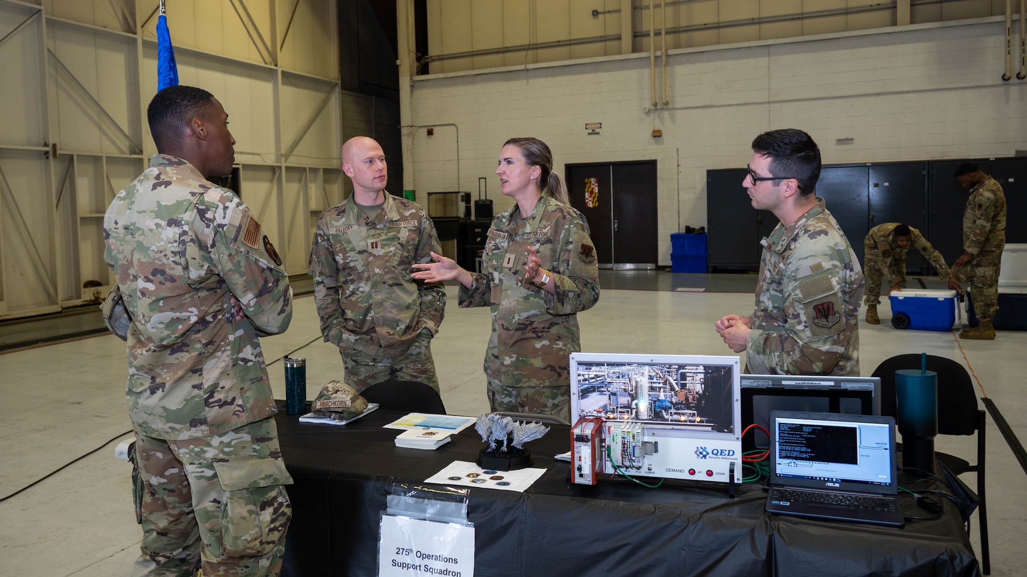 An Airman of the Maryland Air National Guard speaks with members of the 275th Operations Support Squadron during the second day of the 175th Wing Resource Fair at Warfield Air National Guard Base at Martin State Airport, Maryland, May 4, 2025. In response to the planned divestment of the A-10C Thunderbolt II aircraft and mission, each unit of the 175th Wing was represented and available to speak with Airmen to provide information for additional career opportunities in the Maryland Air National Guard. (U.S. Air National Guard Photo by Airman 1st Class Sarah Hoover)