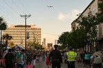 A 433rd Airlift Wing C-5M Super Galaxy performs a flyover to kickoff the 2025 Fiesta Flambeau Parade in downtown San Antonio, Texas May 3, 2025.
