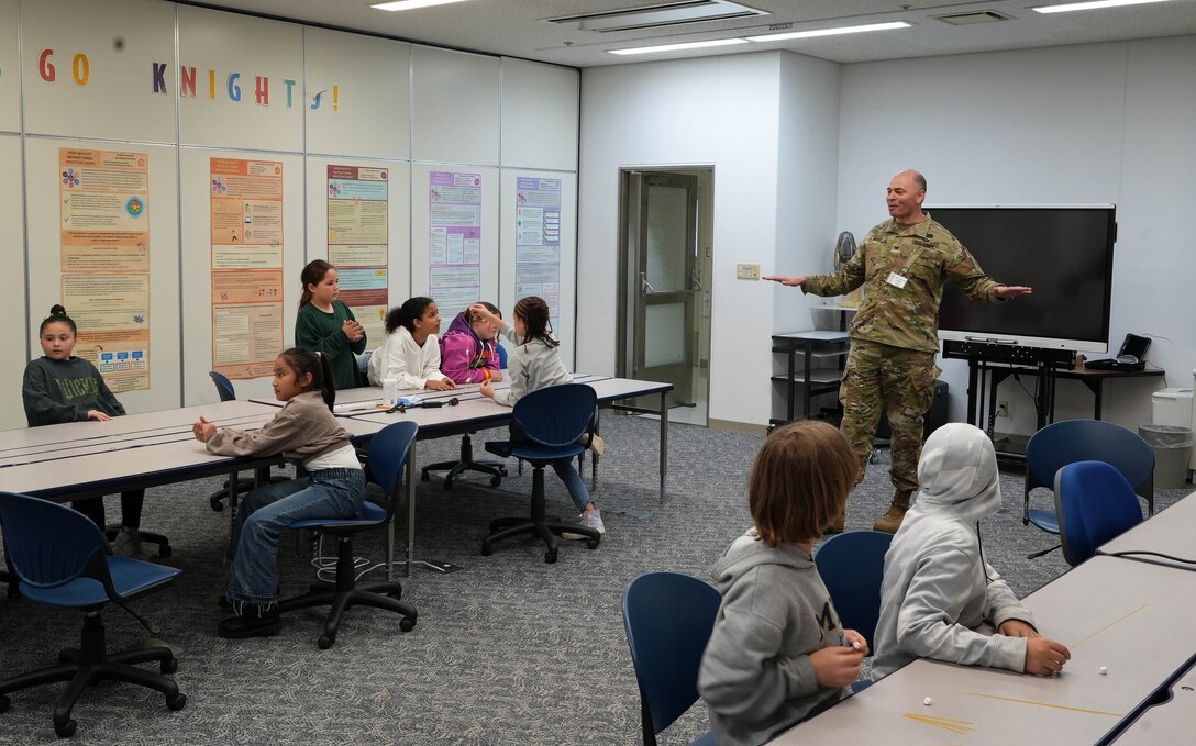 Col. Patrick Biggs, Commander of the U.S. Army Corps of Engineers – Japan District (USACE JED) explains the fundamentals of engineers to a group of John O. Arnn Elementary School students during their annual Science, Technology, Engineering, Art, and Mathematics (STEAM) Day event, April 23, 2025. As part of the Department of Defense Education Activity (DoDEA) curriculum, Arnn’s STEAM Day is a fast-paced event where students are introduced to the dynamic world of STEAM.