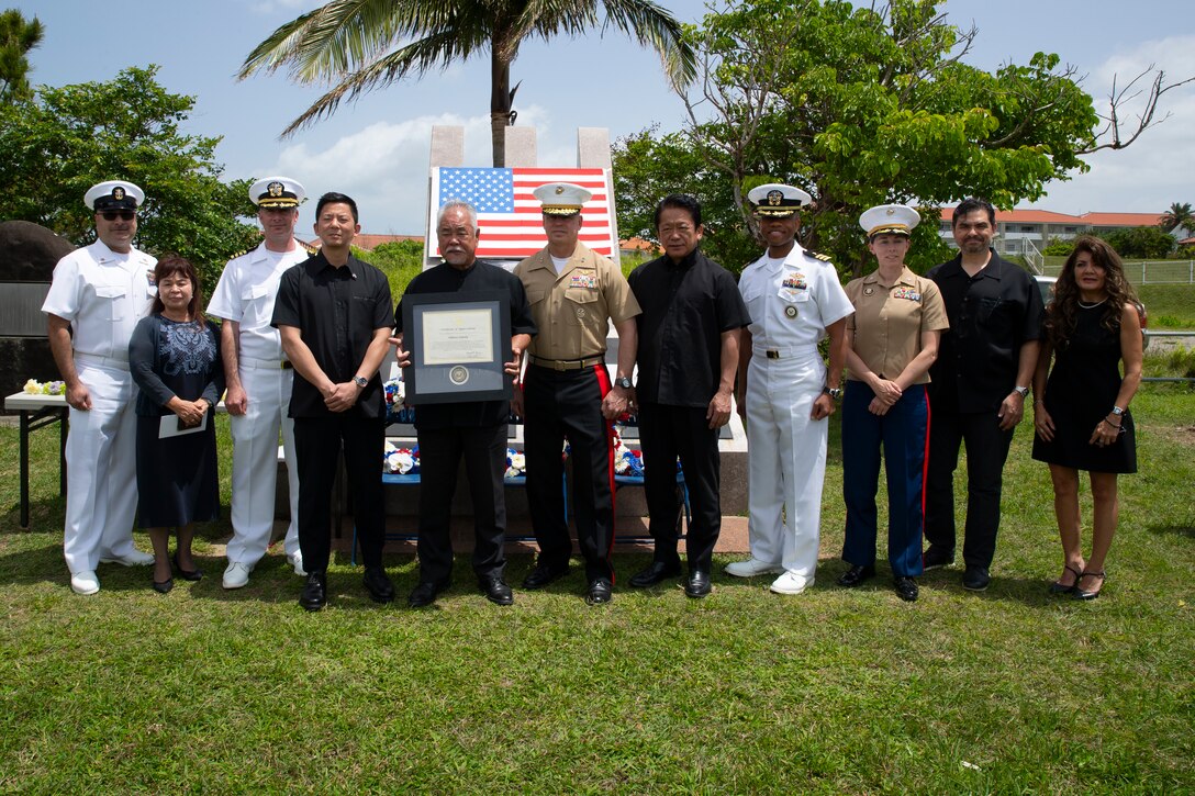 U.S. Marines and Sailors pose for a photo with the Shikana family during the 80th Ishigaki Memorial Ceremony on Ishigaki, Okinawa, Japan, April 15, 2025. The memorial was held to honor the death of 3 naval aviators who died on the island during World War II and to promote peace and friendship. (U.S. Marine Corps photo by Sgt. Frank Webb)