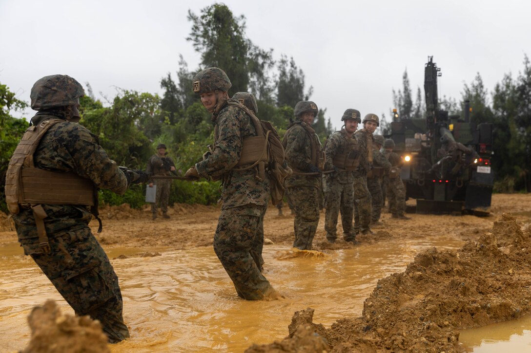 U.S. Marines with Marine Air Support Squadron 2, Marine Air Control Group 18, 1st Marine Aircraft Wing pull a winch cable from a MK36 wrecker on Camp Hansen, Okinawa, Japan, April 23, 2025.The training focused on recovering tactical vehicles in austere environments. (U.S. Marine Corps photo by Cpl. Jeremiah Barksdale)