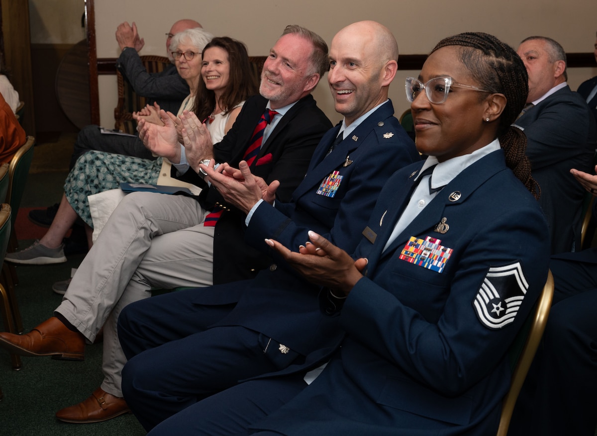 airmen and honorary commanders celebrating new inductees