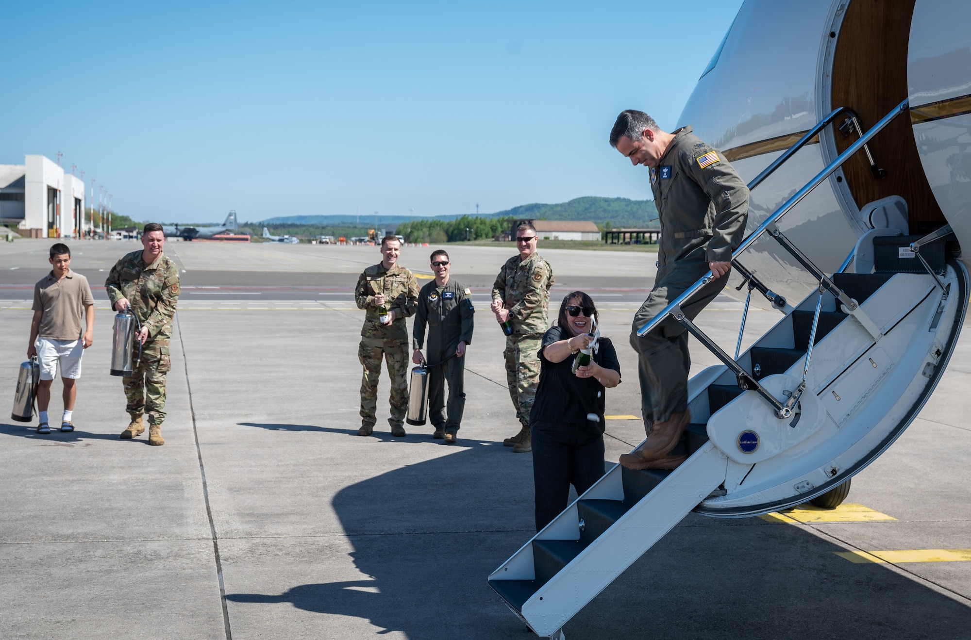 U.S. Air Force Col. Jamil I. Musa, 86th Airlift Wing deputy commander, exits a C-37A Gulfstream after his “fini flight” at Ramstein Air Base, Germany, April 29, 2025. A “fini flight” is a tradition within the U.S. Air Force where a pilot or crew members are celebrated with a water salute upon completion of their final flight at a particular unit or upon retirement. It’s a way to mark their departure and honor their service. (U.S. Air Force photo by Senior Airman Jared Lovett)